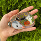 Pumpkin, Ghost, and Bat Sleepy Opossum Mini Stained Glass Suncatcher